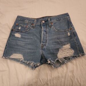 Medium wash distressed button fly, high waist Levi's shorts size 27.